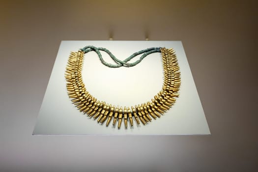 Pre-Columbian gold artifacts in the Museo del Oro. Golden indigenous ornament from South American natives civilization. Famous Gold Museum, Bogota, Colombia.