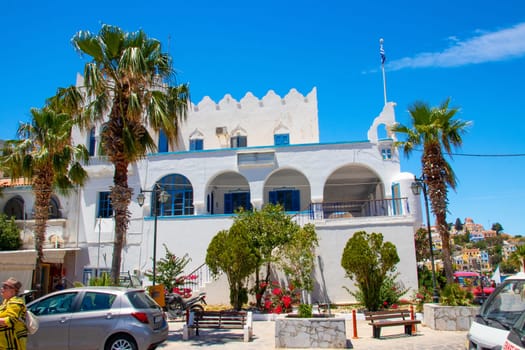 SYMI, Greece - 03 JUNE 2021: The building of the police station is located at the entrance to the harbour of Symi next to the clock tower (Roloi). Helenic police.