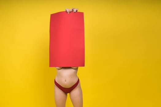 Blonde model, Young woman holding a cardboard cloud red sheet of papaer, place for an inscription