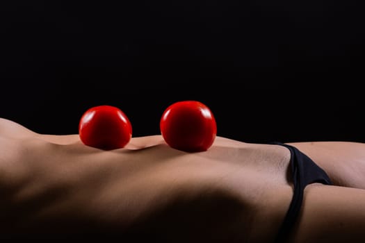 Female with tomatoes on chest and back, concept of healthy food and female health