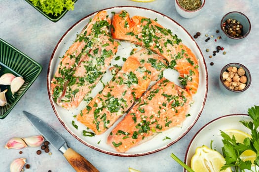 Raw uncooked salmon or trout fillet fish in garlic green marinade. Flat lay