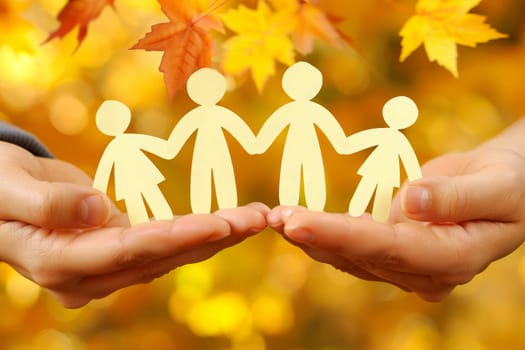 Two hands delicately hold a paper cutout of a family, symbolizing unity and love in a creative and imaginative way.