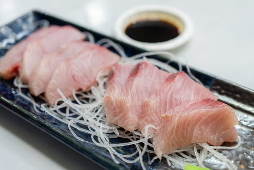 Slice of fish sashimi on plate