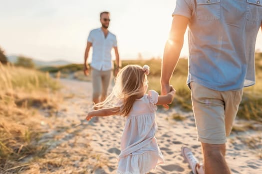 A girl in a white dress leads her father by the hand along a beach as the sun sets.