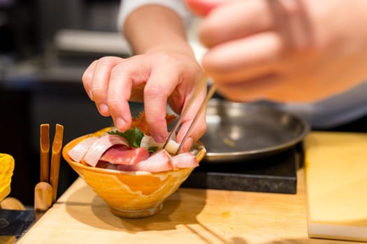 Japanese chef make of sashimi rice bowl