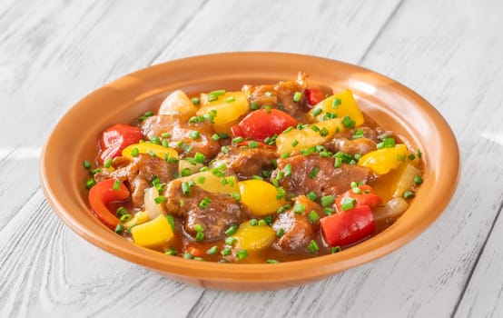 Portion of sweet and sour pork with bell pepper and pineapple