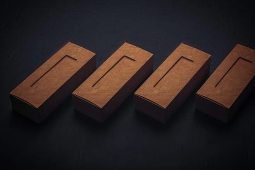 Four sleek, brown packaging boxes aligned perfectly on a matte surface, exuding modern sophistication.