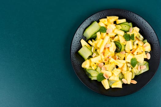 Tasty vegetarian appetizing salad pineapple, cucumber and nuts salad. Space for text.