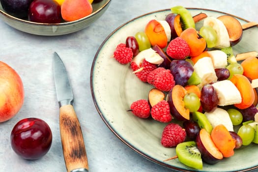 Juicy fruit skewers made from fresh fruits on wooden skewers.