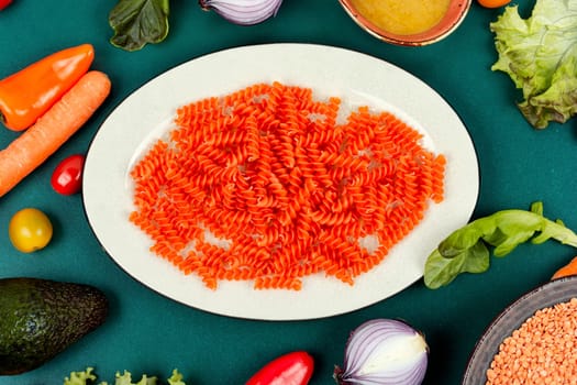 Uncooked pasta, red lentil gluten free fusilli pasta. Raw and dry macaroni.
