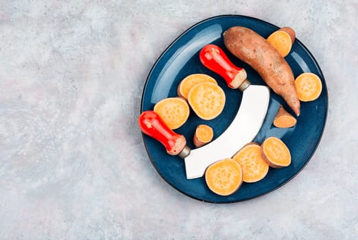 Raw sweet potatoes or batatas. Healthy eating concept, dietary food. Copy space.