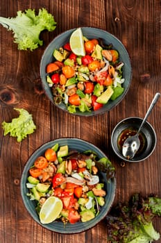 Seafood salad with shrimp, octopus, mussels, tomatoes, avocado and mixed greens. Healthy food.