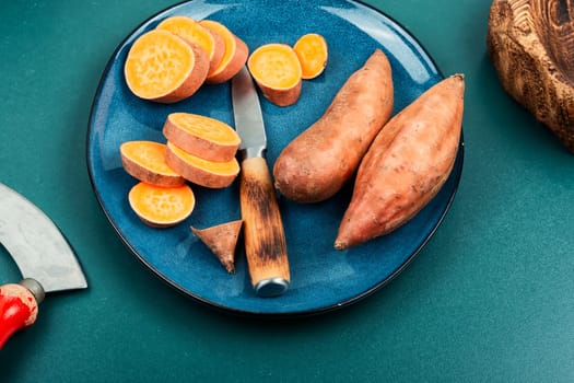 Raw sweet potatoes or batatas. Healthy eating concept, dietary food. Copy space.