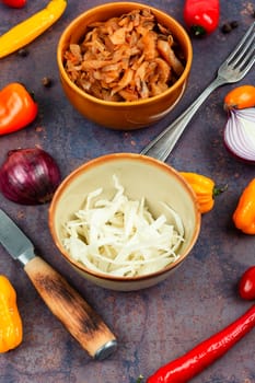 Appetizing stewed cabbage on the old wooden background. Top view, copy space