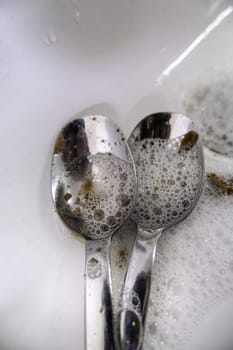 Detail of cleaning dishes with soap and water, hygiene