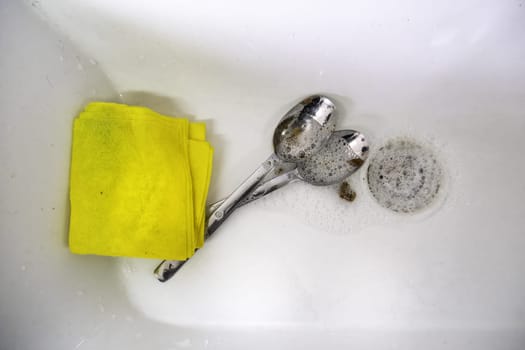 Detail of cleaning dishes with soap and water, hygiene