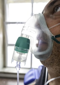 Detail of a sick person in a hospital with oxygen to breathe