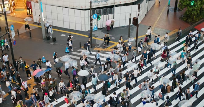 Tokyo, Japan 30 June 2019: People cross the road in Ikebukuro district at night
