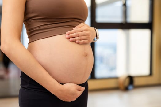 Pregnant woman in the yoga studio