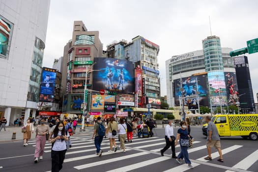 Taipei, Taiwan 13 September 2023: People cross the road in Taipei city street in Ximending