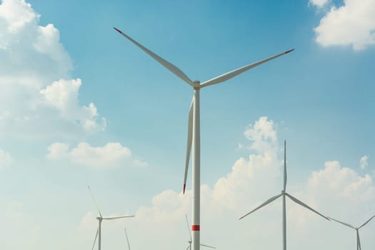 Sustainable green energy. Electric windmill generators in the sunrise