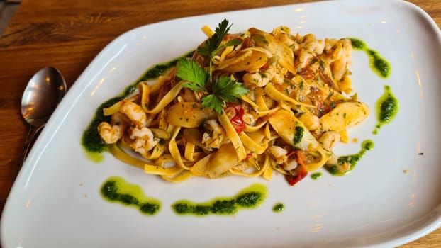 Tagliatelle pasta with mushrooms in a creamy sauce with parmesan and white wine, horizontal