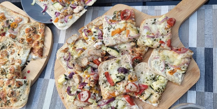 French tarte flambee with cream cheese, bacon and onions. Flammkuchen from Alsace region. Dark background. Top view