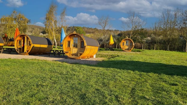 A barrel campground in the French countryside. Blue skies and green grass and a lot of relaxation.