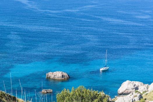 Picturesque sea landscape with bay and sailing ship on Mallorca, Baleares in Spain.