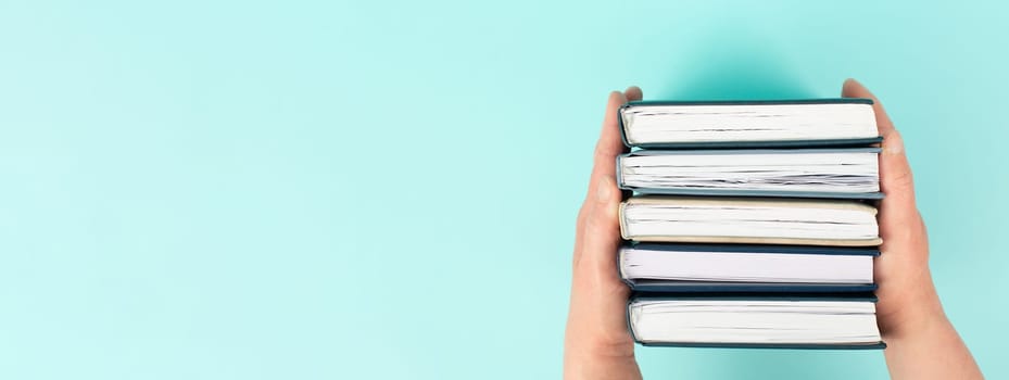 Hands holding pile of books, reading and learning new skill, knowledge is power, education concept, university student, back to school