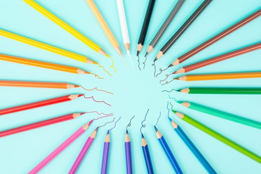Color pencils collection in a row, back to school, drawing supplies, blue background with copy space