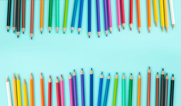 Color pencils collection in a row, back to school, drawing supplies, blue background with copy space