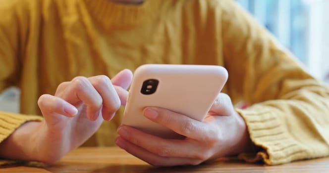 Woman use of cellphone at coffee shop
