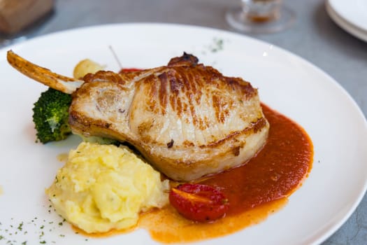 Grill pork fillet with bone and potato mash in the restaurant