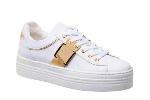 White sneaker isolated. Close-up of a single white elegant stylish female leather high-heeled sport shoes isolated. Clipping path. Modern design footwear for workout.