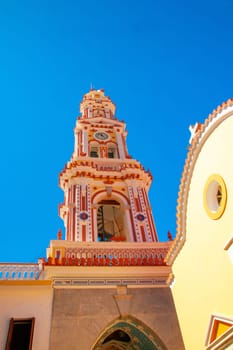 SYMI, Greece - JUN 03, 2021. SYMI, Greece - JUN 03, 2021. Panormitis Monastery of Archangel Michael in the southwest of the island of Symi is an important orthodox pilgrimage site and an important tourist attraction.