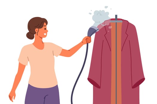 Steam iron in hand of woman caring for clothes after washing and enjoying housework. Happy housewife with steam iron to disinfect and clean stains from outerwear or evening dresses