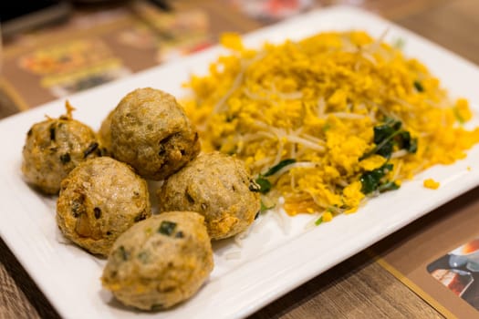 Fish meat ball with fry egg in the restaurant