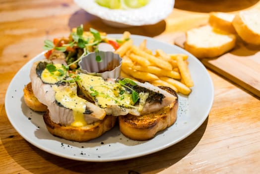 Grill fish on the toast with French fry in the restaurant