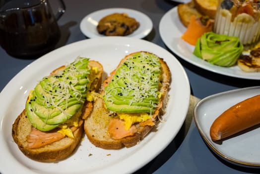 Sliced avocado on salmon toast bread with spices