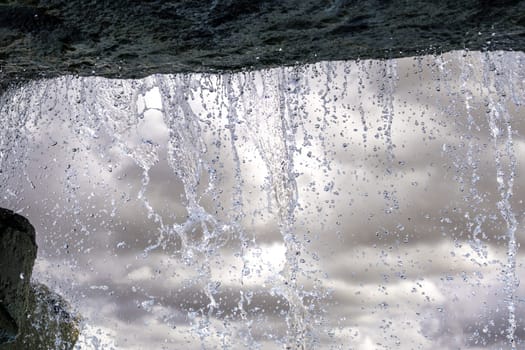 Detail of artificial waterfall in a swimming pool in summer