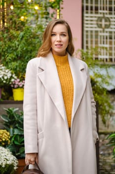 Outdoor portrait of pretty woman in coat
