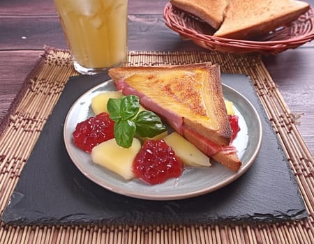 Toast Hawaii, cheese and pineapple on wooden background with chicken breast