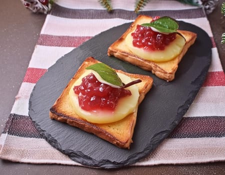 Toast Hawaii, cheese and pineapple on wooden background with chicken breast