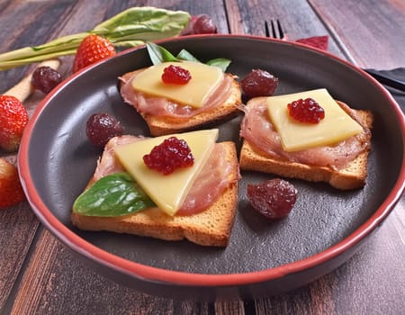Toast Hawaii, cheese and pineapple on wooden background with chicken breast