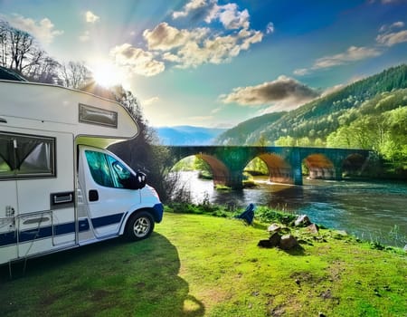 Camping on the beautiful river in summer with an old bridge in the background