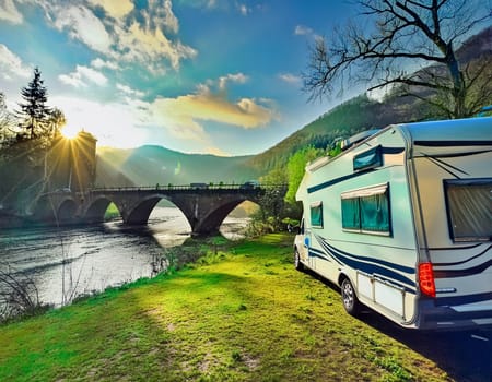 Camping on the beautiful river in summer with an old bridge in the background
