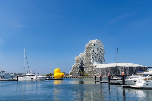 Taiwan, 01 February 2024: Kaohsiung Music Center with yellow duck floating over the bay