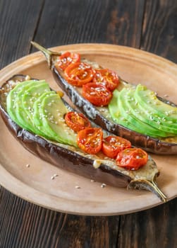 Baked eggplant with cheese, avocado and tomatoes