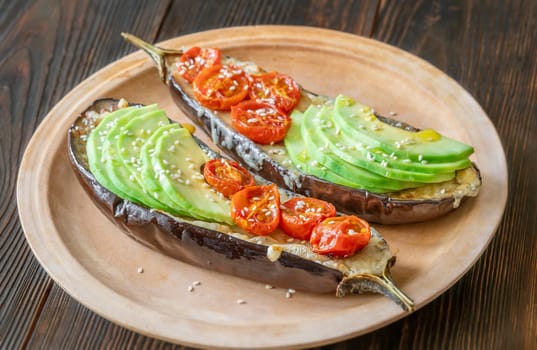Baked eggplant with cheese, avocado and tomatoes